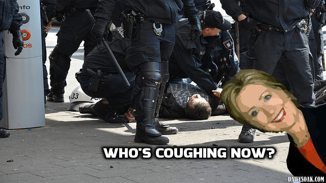Funny satire photo of Hillary Clinton standing in front of a man being tackled by police.