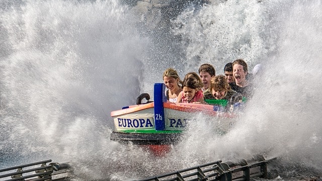 Children riding in an Europa Park amusement water ride with water splashing everywhere.
