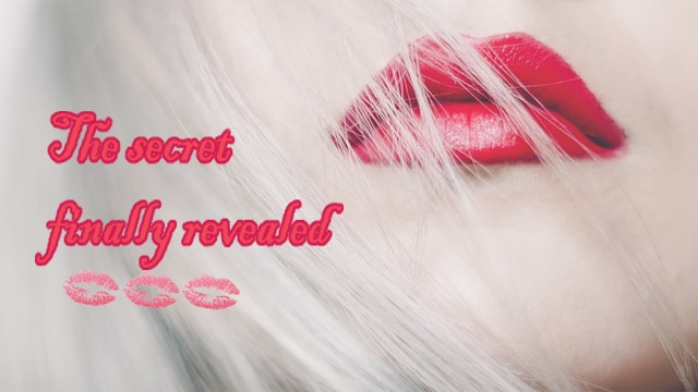 Closeup of a beautiful blonde woman's red lips.