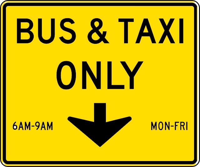 Yellow sign with black letters that says Bus And Taxi Only.