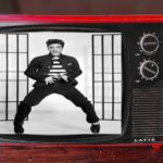 Black and white Elvis Presley dancing on red vintage TV in Tennessee apartment.