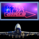 Neon sign of stripping women over an airplane.