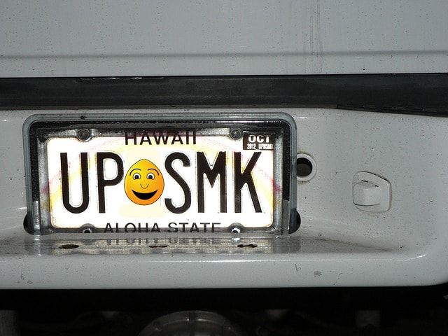 Satire license plate with emoticon on it.