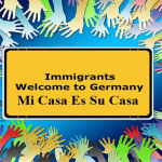 Numerous multi-colored hands reaching toward a sign.