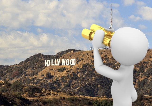 Cartoon man with gold binoculars looking at Hollywood sign.
