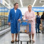 Woman and man in bathrobe inside of Walmart.