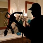 Black silhouette of man with bow and arrow.