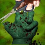 Man using scissors to cut off zombie's thumb.