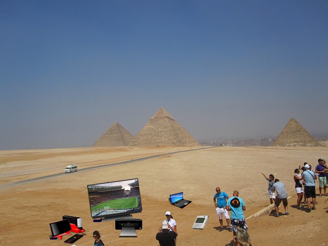 Archaeologists standing near Egyptian pyramid.