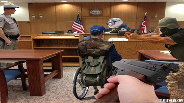 Man in wheelchair inside courtroom with judge and police.