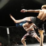 Funny kickboxing parody with one man with kangaroo legs kicking another man in face inside ring.