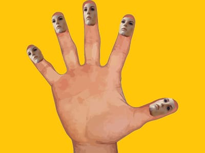 Hand with face fingers against yellow background.