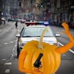 Orange pumpkin holding gun in New York City.
