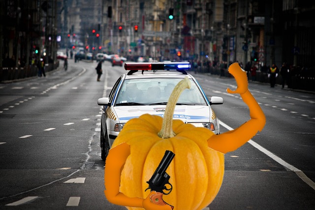 Orange pumpkin holding gun in New York City.