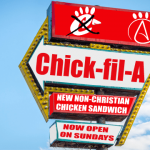 Red and white Chick-fil-A sign against blue sky.