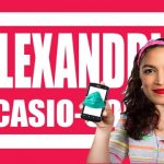 Alexandria Ocasio-Cortez holding smartphone against pink background of her name.
