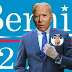 Joe Biden in blue suit wearing Bernie Sanders political pin.