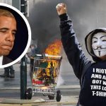 Man wearing mask and black clothes burning shopping cart.