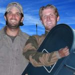 Donald Jr. and Eric Trump holding up a blue mailbox.