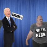 Bernie Sanders and Joe Biden on stage in front of blue curtain.