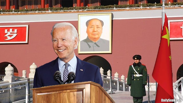 Joe Biden wearing blue suit in front of China flags and soldiers.