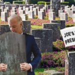 Joe Biden in blue suit hugging tombstone inside cemetery.