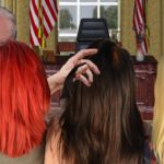 Joe Biden inside Oval Office sniffing a red headed woman's hair.