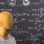 Mannequin in white shirt in front of chalkboard.