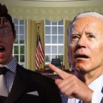 Joe Biden wearing suit inside Oval Office pointing at man wearing glasses.