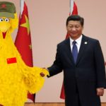 Big Bird shaking hands with President Xi near China flags.