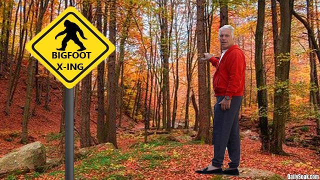 Jeffrey Epstein standing in wooded forest near a yellow Bigfoot sign.