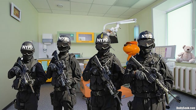 Four armed NYPD police officers standing inside New York City hospital room.