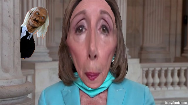 Nancy Pelosi wearing a blue suit during a news press conference.
