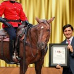 Justin Trudeau giving medal of bravery to Canadian Royal Mountie.