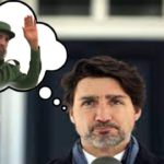 Justin Trudeau next to a photo of Fidel Castro.