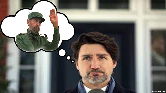 Justin Trudeau next to a photo of Fidel Castro.