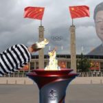 Parody China Olympics with a man holding a Uyghur prisoner's head over the Olympic cauldron.