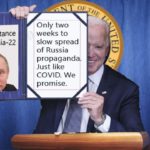 Joe Biden holding up sign with Russia President Vladimir Putin on it.