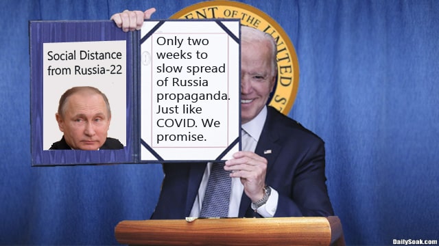 Joe Biden holding up sign with Russia President Vladimir Putin on it.