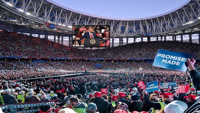 Large Super Bowl football stadium filled with Donald Trump supporters.