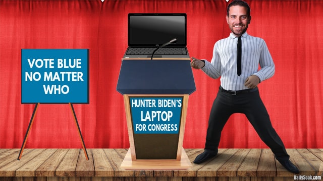 Hunter Biden standing next to his laptop on stage.
