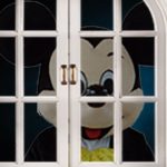Disney Mickey Mouse rodent staring into bedroom at night.