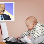 Joe Biden standing near a baby on computer laptop.