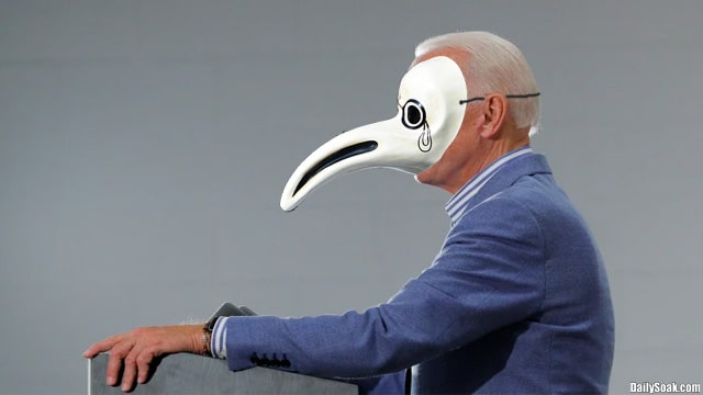 President Joe Biden on stage wearing a Black Death face mask.