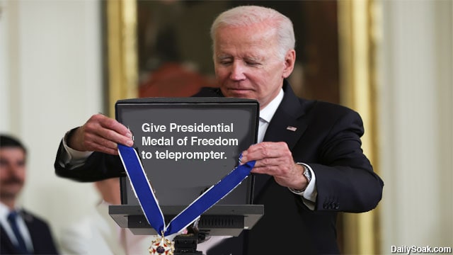 President Joe Biden presenting Presidential Medal of Freedom to a teleprompter.