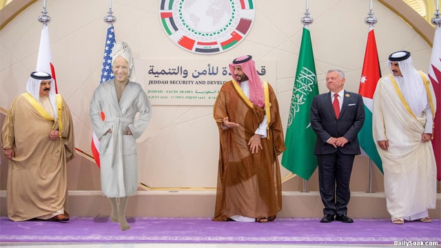 Joe Biden wearing white towel and bath robe next to Saudi Arabia prince.