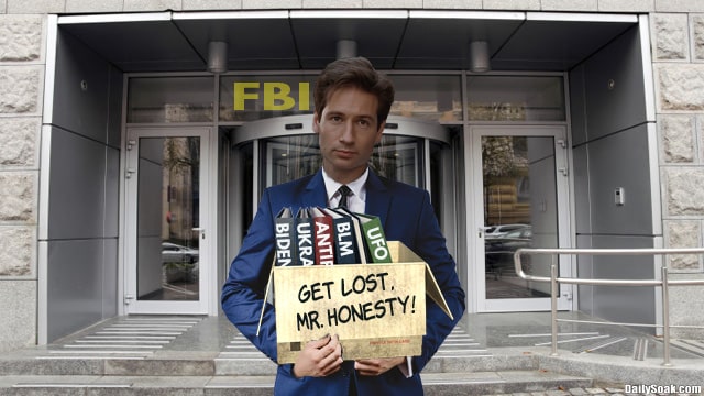 FBI Agent Fox Mulder carrying a box of books.