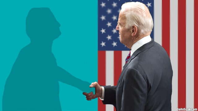 Joe Biden shaking hands with the air onstage.