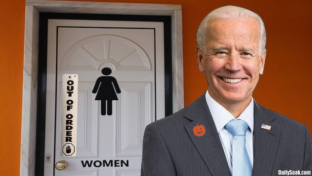 Joe Biden standing near a women's bathroom painted orange for Halloween.