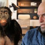 John Fetterman with a caveman getting speaking lessons.